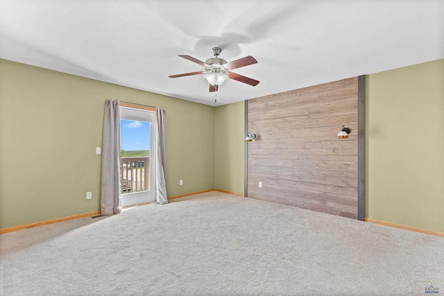 4300 Donegal Way, Rapid City, SD 57702 - unfurnished room featuring wooden walls, a ceiling fan, carpet flooring, and baseboards