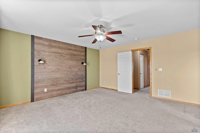 4300 Donegal Way, Rapid City, SD 57702 - empty room featuring ceiling fan, carpet floors, baseboards, and wood walls