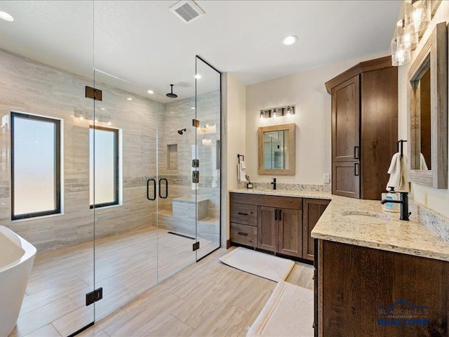 11311 Overlook Ct, Lead, SD 57754 - bathroom with a stall shower, two vanities, a freestanding tub, and recessed lighting