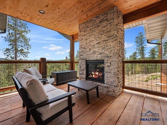 11311 Overlook Ct, Lead, SD 57754 - wooden terrace with an outdoor stone fireplace
