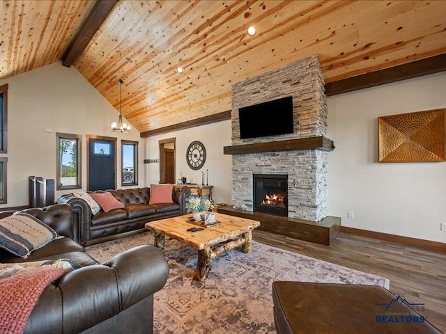 11311 Overlook Ct, Lead, SD 57754 - living room featuring wood finished floors, a chandelier, wood ceiling with exposed beams, baseboards, and a stone fireplace