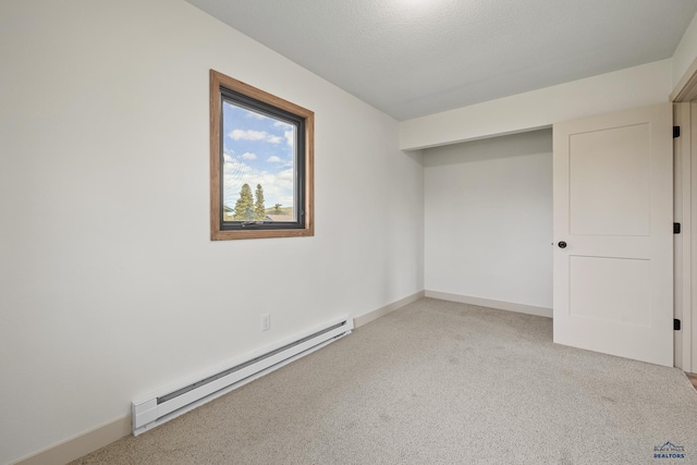 248 S 10th St, Custer, SD 57730 - unfurnished bedroom featuring baseboard heating, light carpet, and baseboards