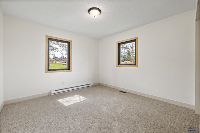 248 S 10th St, Custer, SD 57730 - carpeted spare room with baseboard heating, plenty of natural light, and baseboards