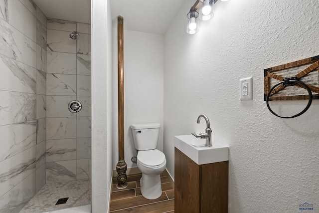 248 S 10th St, Custer, SD 57730 - full bathroom featuring toilet, tiled shower, wood finish floors, and vanity