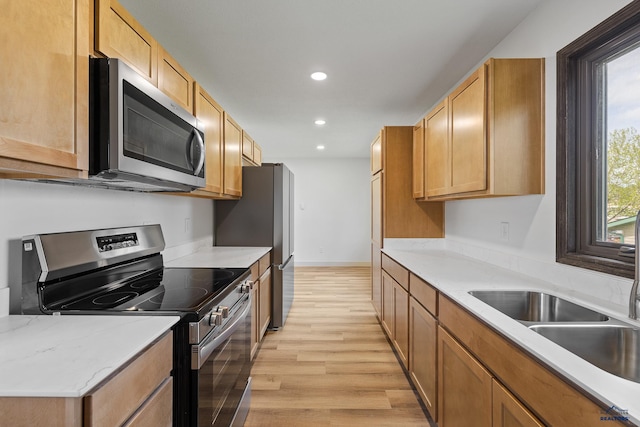 248 S 10th St, Custer, SD 57730 - kitchen featuring stainless steel appliances, a sink, light wood-type flooring, recessed lighting, and light countertops