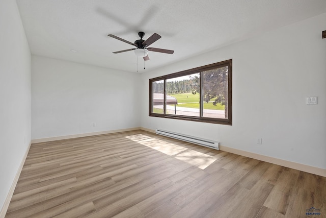248 S 10th St, Custer, SD 57730 - empty room featuring baseboard heating, wood finished floors, ceiling fan, and baseboards