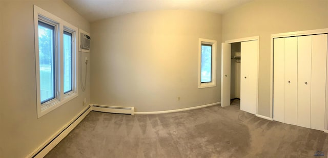 305 S Canyon Rd Unit 8D, Rapid City, SD 57702 - unfurnished bedroom featuring multiple windows, baseboard heating, and carpet floors