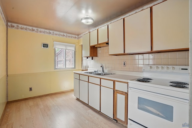 1905 5th St, Rapid City, SD 57701 - kitchen with white electric range oven, a sink, light wood-type flooring, light countertops, and decorative backsplash