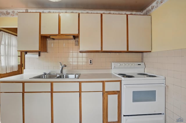1905 5th St, Rapid City, SD 57701 - kitchen featuring electric stove, a sink, tile walls, and light countertops