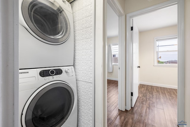 814 Flormann, Rapid City, SD 57701 - laundry area with stacked washing machine and dryer, dark wood finished floors, and baseboards