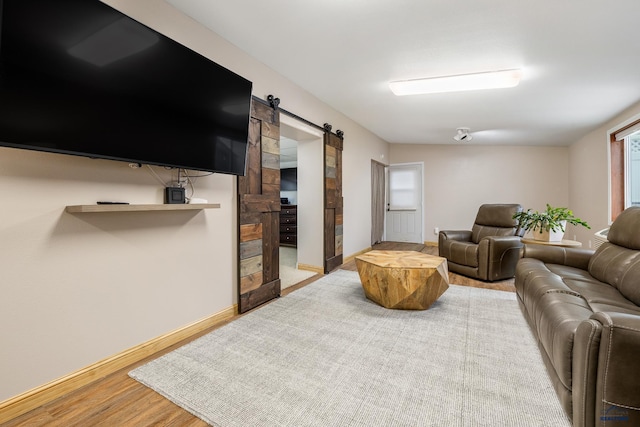 814 Flormann, Rapid City, SD 57701 - living area featuring a barn door, wood finished floors, and baseboards