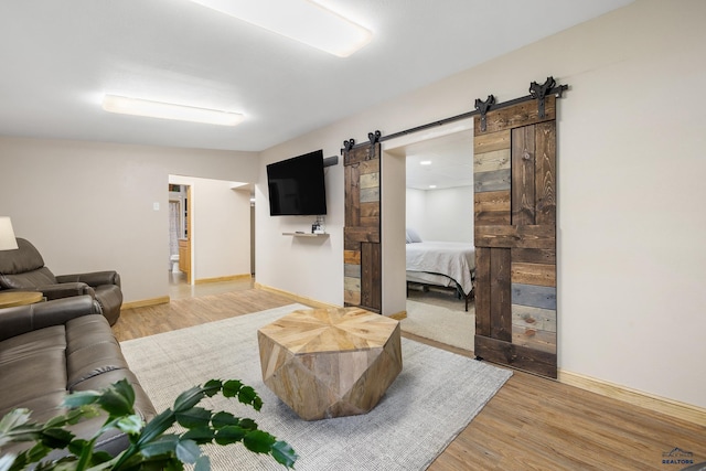 814 Flormann, Rapid City, SD 57701 - living room featuring a barn door, wood finished floors, and baseboards
