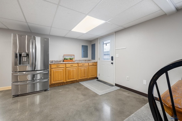 814 Flormann, Rapid City, SD 57701 - kitchen featuring stainless steel refrigerator with ice dispenser, baseboards, electric panel, a paneled ceiling, and brown cabinets