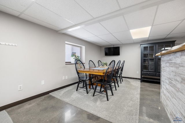 814 Flormann, Rapid City, SD 57701 - dining room with baseboards, a paneled ceiling, and finished concrete floors