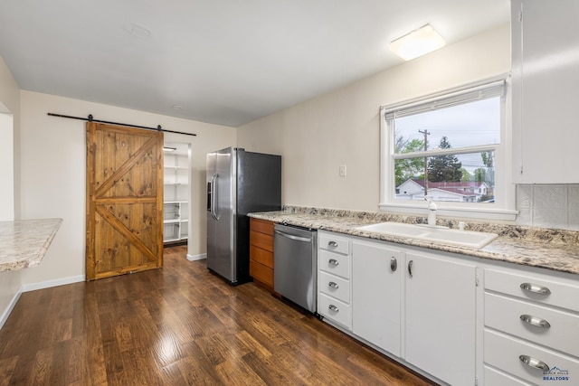814 Flormann, Rapid City, SD 57701 - kitchen with stainless steel appliances, dark wood finished floors, a sink, and white cabinetry
