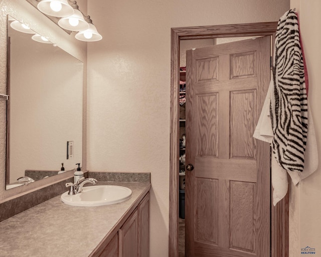 7410 Pinewood Ct, Rapid City, SD 57702 - bathroom featuring vanity and a textured wall