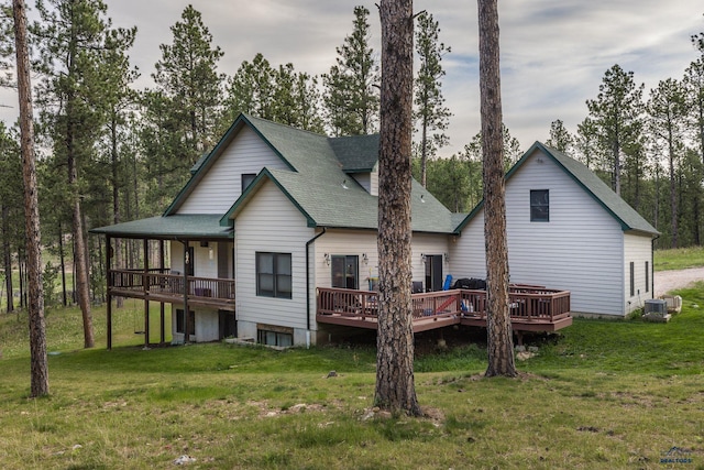 7410 Pinewood Ct, Rapid City, SD 57702 - back of property with roof with shingles, a deck, a yard, and central AC