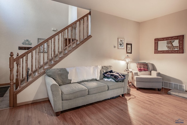 7410 Pinewood Ct, Rapid City, SD 57702 - living area with wood finished floors, stairway, and baseboards