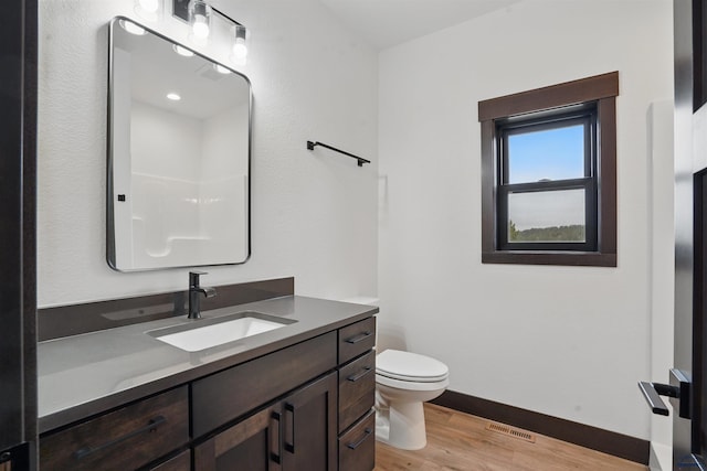 12290 Prairie View Loop, Whitewood, SD 57793 - bathroom featuring wood finished floors, toilet, vanity, and baseboards