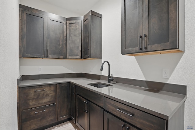 12290 Prairie View Loop, Whitewood, SD 57793 - kitchen with a sink, dark brown cabinetry, and a textured wall