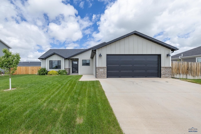 3408 Jim St, Rapid City, SD 57703 - view of front facade with stone siding, driveway, a garage, and board and batten siding