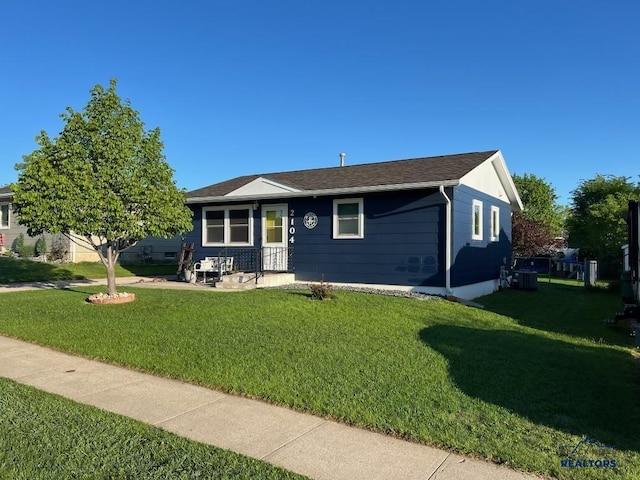 2104 Colorado, Sturgis, SD 57785 - view of front of home with a front lawn, roof with shingles, and central AC unit