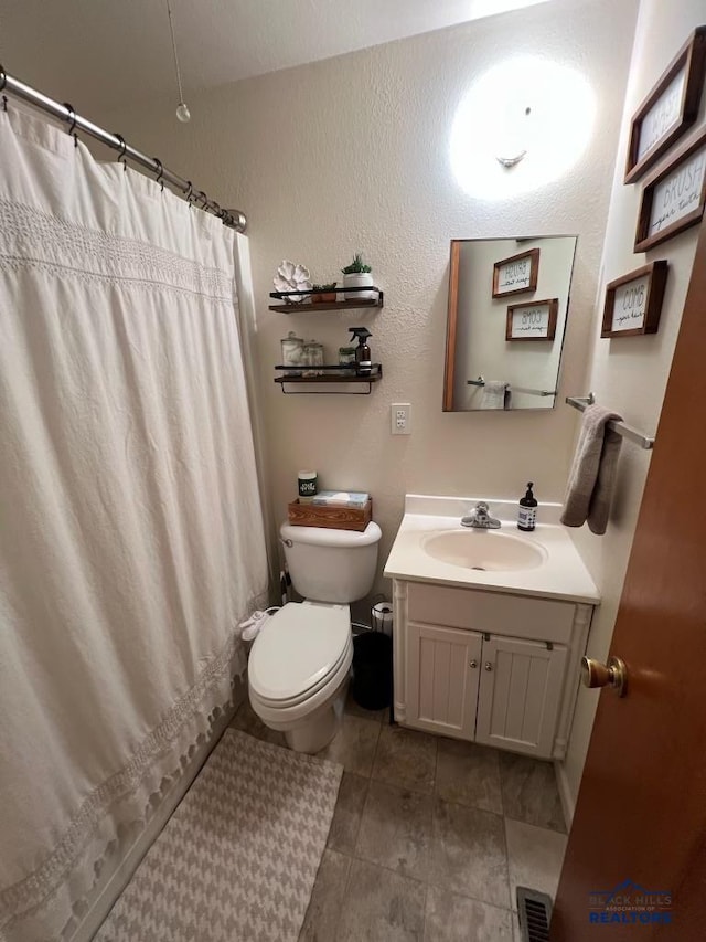2104 Colorado, Sturgis, SD 57785 - full bath featuring toilet, vanity, a shower with shower curtain, and tile patterned floors