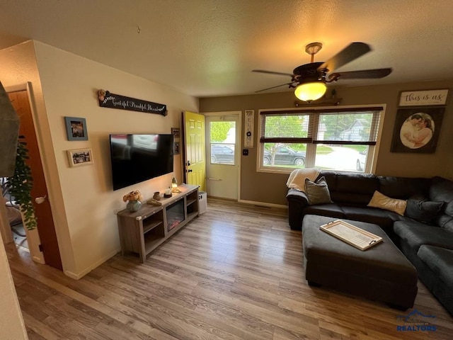 2104 Colorado, Sturgis, SD 57785 - living room with light wood finished floors, baseboards, ceiling fan, and a textured ceiling