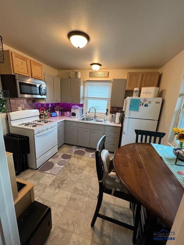 2104 Colorado, Sturgis, SD 57785 - kitchen featuring white appliances, a sink, light countertops, and gray cabinetry