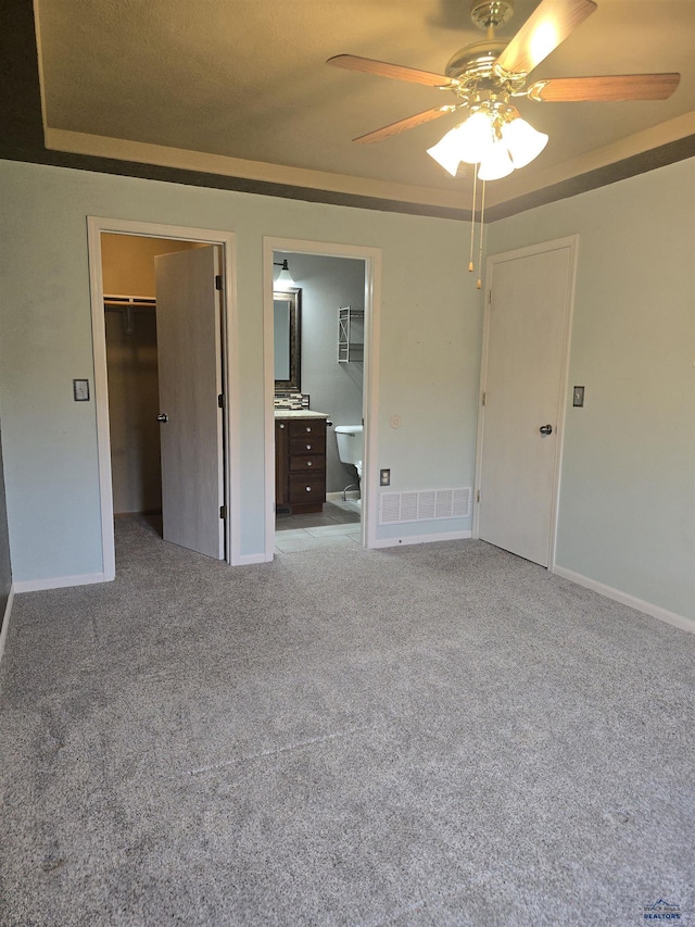 14655 Telluride St, Summerset, SD 57769 - unfurnished bedroom featuring a walk in closet, a closet, carpet, baseboards, and ensuite bath