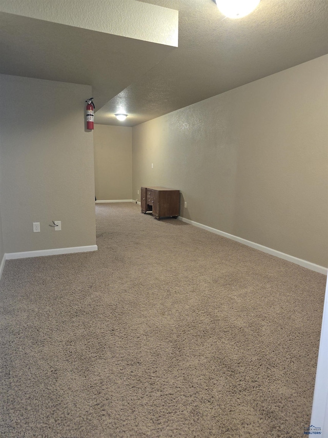 14655 Telluride St, Summerset, SD 57769 - finished below grade area with carpet floors, baseboards, and a textured ceiling