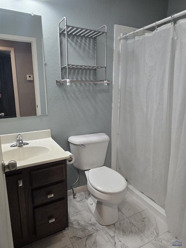 14655 Telluride St, Summerset, SD 57769 - bathroom with vanity, toilet, marble finish floors, baseboards, and curtained shower
