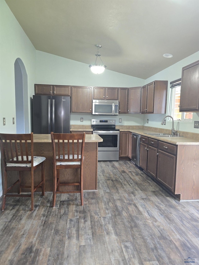 14655 Telluride St, Summerset, SD 57769 - kitchen featuring appliances with stainless steel finishes, lofted ceiling, a sink, dark wood-style floors, and light countertops