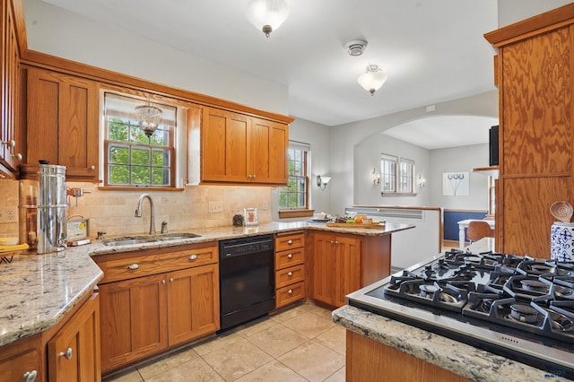 902 Fulton St, Rapid City, SD 57701 - kitchen featuring black dishwasher, stovetop, brown cabinets, a sink, and light tile patterned flooring