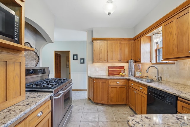902 Fulton St, Rapid City, SD 57701 - kitchen featuring stainless steel appliances, a sink, open shelves, light stone counters, and backsplash