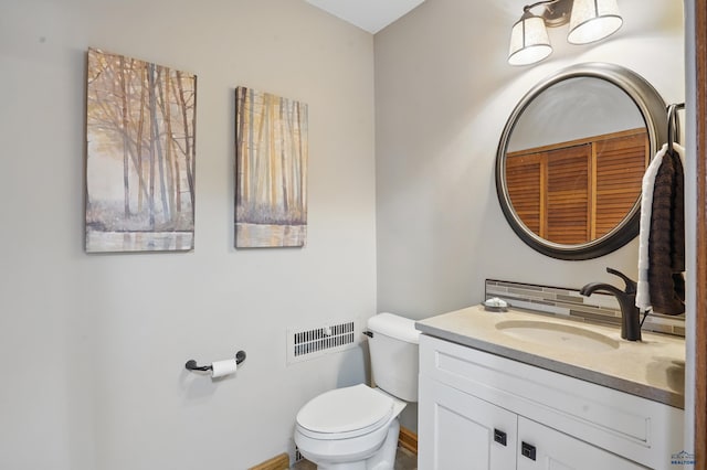 902 Fulton St, Rapid City, SD 57701 - half bathroom with toilet, vanity, tasteful backsplash, and baseboards