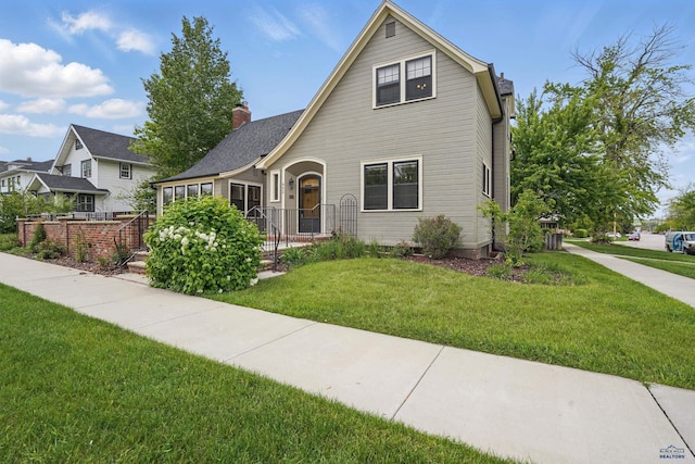902 Fulton St, Rapid City, SD 57701 - view of front of home with a front yard and a chimney