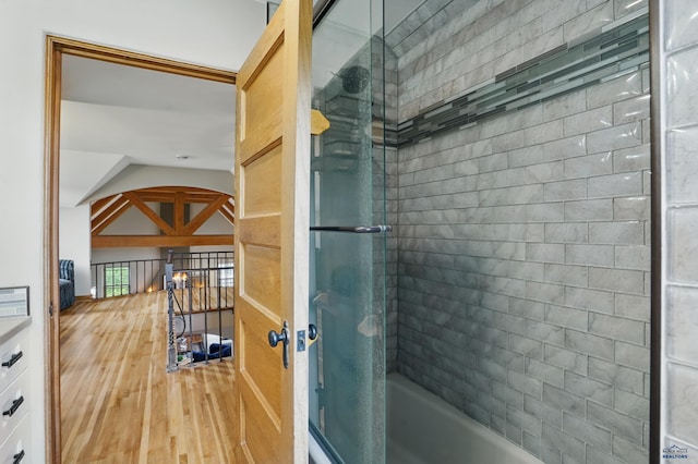 902 Fulton St, Rapid City, SD 57701 - full bath with combined bath / shower with glass door and wood finished floors