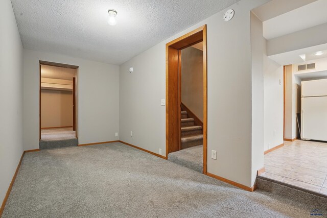 902 Fulton St, Rapid City, SD 57701 - unfurnished bedroom with freestanding refrigerator, carpet, a textured ceiling, and baseboards