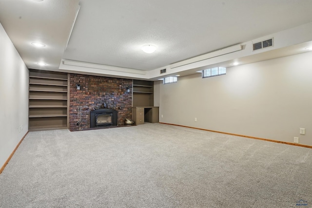902 Fulton St, Rapid City, SD 57701 - below grade area featuring baseboards, carpet floors, a textured ceiling, and a brick fireplace