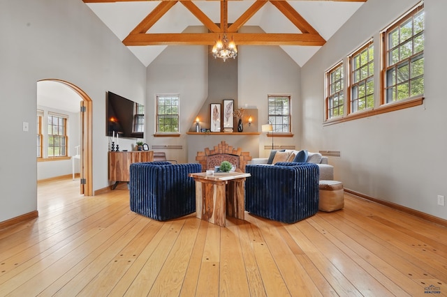 902 Fulton St, Rapid City, SD 57701 - living room featuring high vaulted ceiling, a chandelier, light wood finished floors, beam ceiling, and plenty of natural light