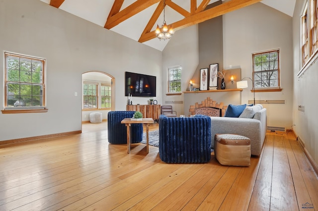 902 Fulton St, Rapid City, SD 57701 - living room with high vaulted ceiling, healthy amount of natural light, a chandelier, beam ceiling, and light wood-style flooring