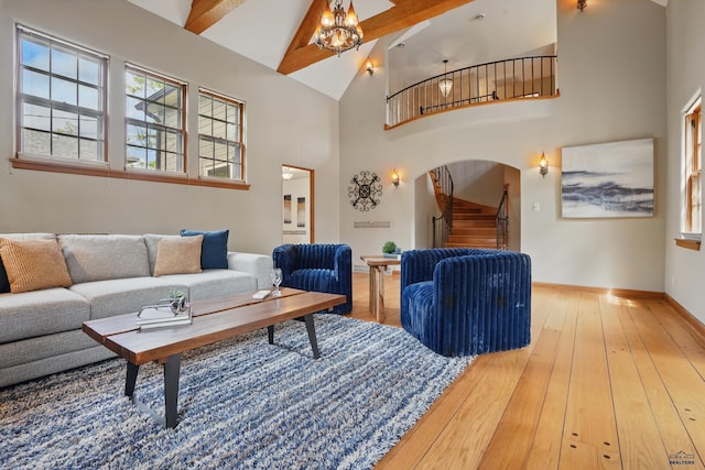 902 Fulton St, Rapid City, SD 57701 - living room with stairway, arched walkways, high vaulted ceiling, beam ceiling, and hardwood / wood-style floors