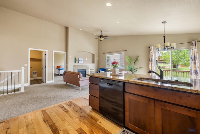 3216 Eunice Dr, Rapid City, SD 57703 - kitchen featuring dishwasher, a sink, light wood-style floors, pendant lighting, and stone counters