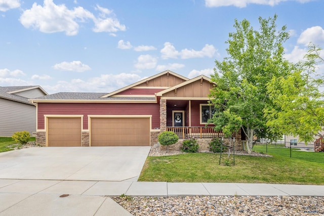 3216 Eunice Dr, Rapid City, SD 57703 - craftsman-style house featuring board and batten siding, an attached garage, stone siding, driveway, and covered porch