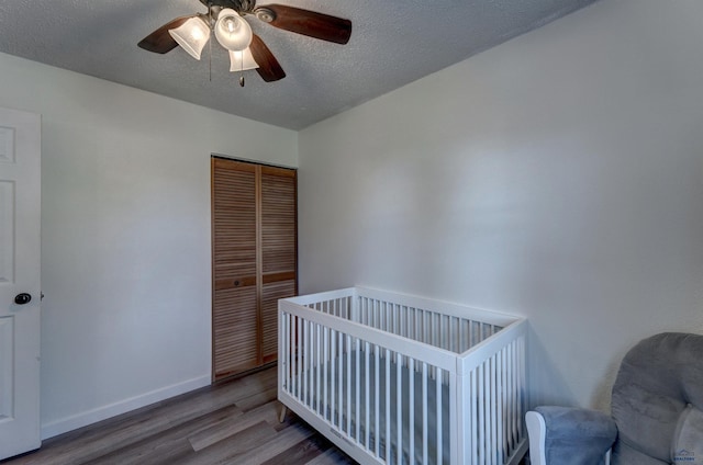 426 E Oakland, Rapid City, SD 57701 - bedroom featuring wood finished floors, a closet, baseboards, ceiling fan, and a textured ceiling