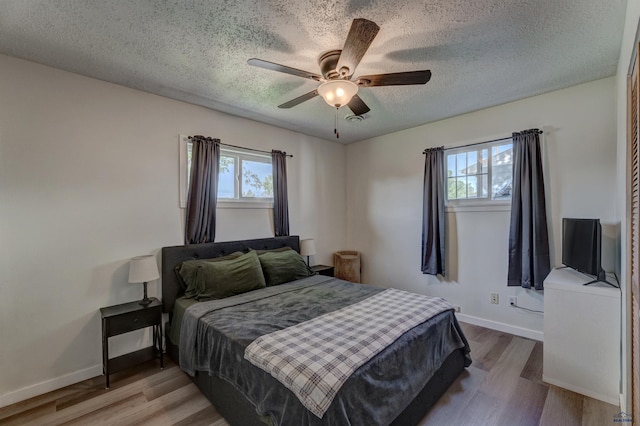 426 E Oakland, Rapid City, SD 57701 - bedroom featuring a textured ceiling, wood finished floors, baseboards, and ceiling fan