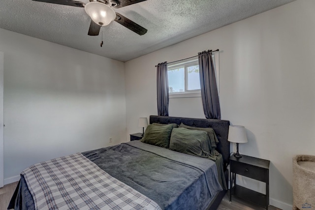 426 E Oakland, Rapid City, SD 57701 - bedroom with wood finished floors, a textured ceiling, baseboards, and ceiling fan