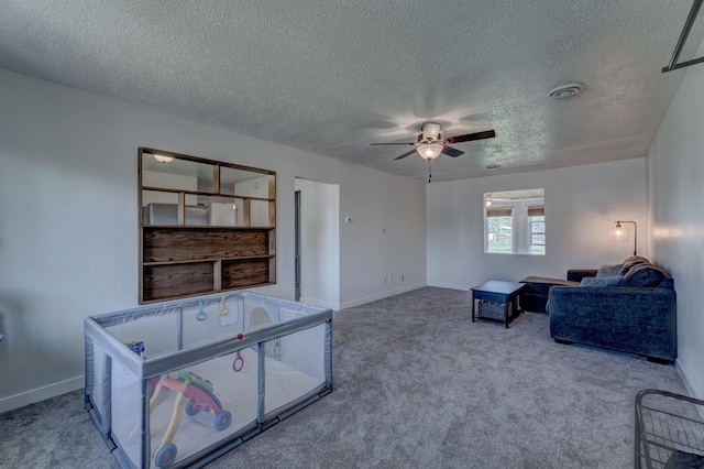 426 E Oakland, Rapid City, SD 57701 - living area with carpet, a textured ceiling, baseboards, and a ceiling fan