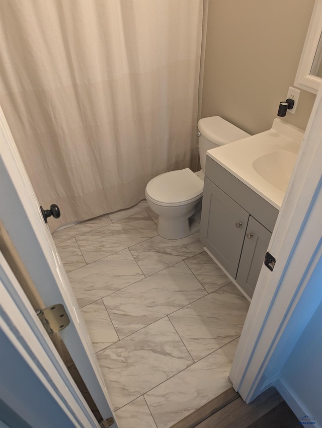 426 E Oakland, Rapid City, SD 57701 - bathroom with marble finish flooring, vanity, and toilet